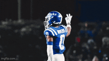 a duke football player wearing a blue helmet
