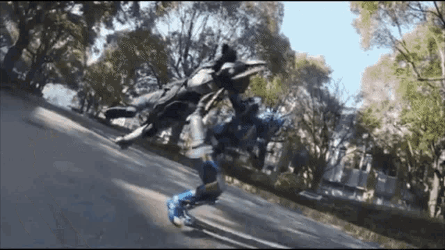 a person rollerblading down a street with a statue in the background