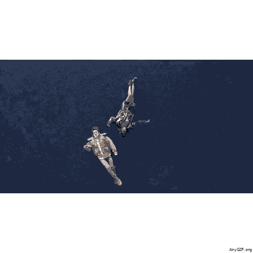 an aerial view of a man and a woman laying on a blue surface