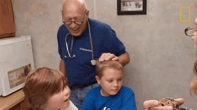a man with a stethoscope around his neck is talking to a group of children