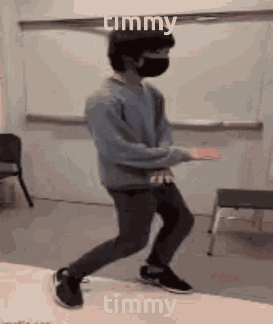 a man wearing a mask is dancing in a room with the name timmy written on it .
