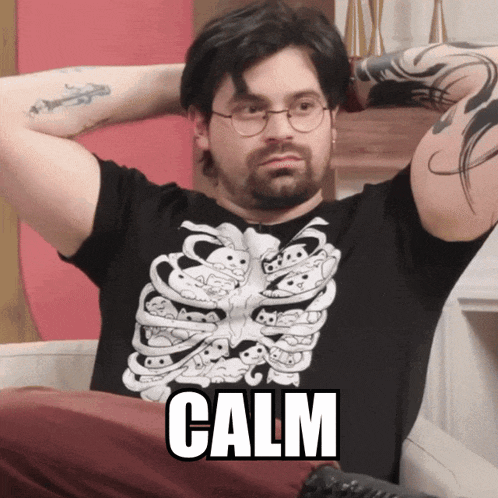 a man wearing a black shirt with a skeleton on it says calm