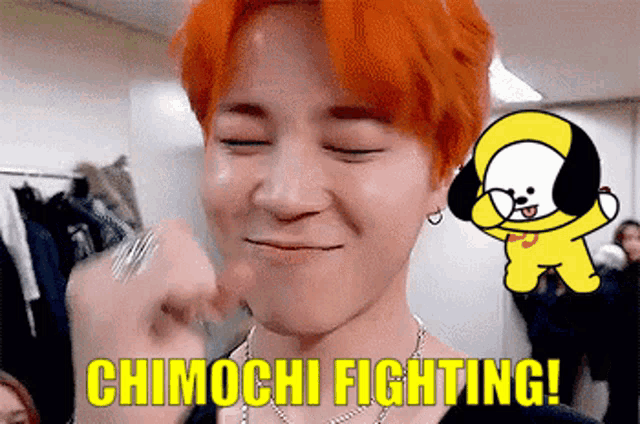 a man with red hair is holding a fist in front of a cartoon character that says chimchi fighting !