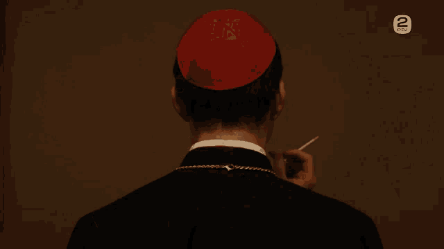 a priest smoking a cigarette with the number 2 on the bottom left
