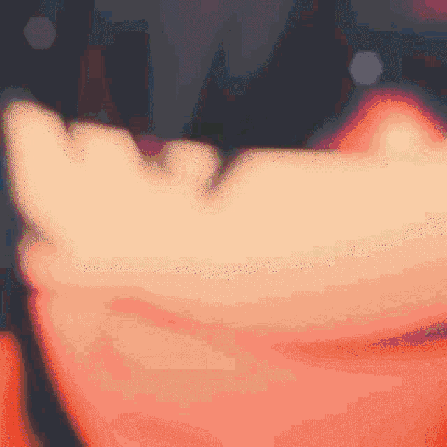 a close up of a person 's hand holding something in their hand .