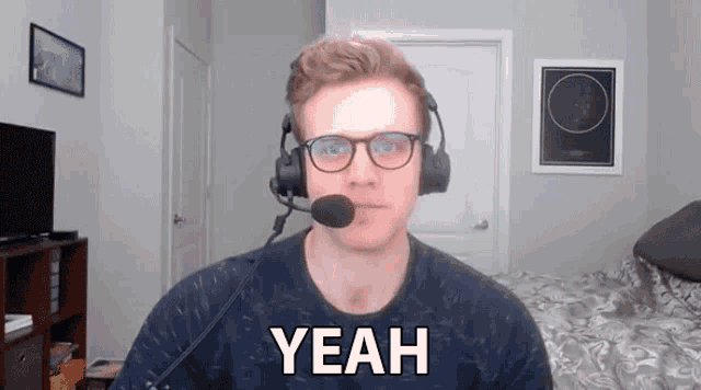 a man wearing headphones and a microphone says " yeah "