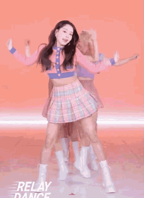 a group of girls are dancing in front of a relay dance logo