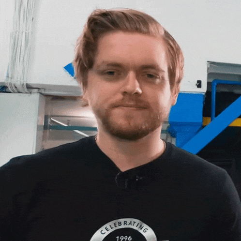a man wearing a black shirt that says celebrating 1996 on it