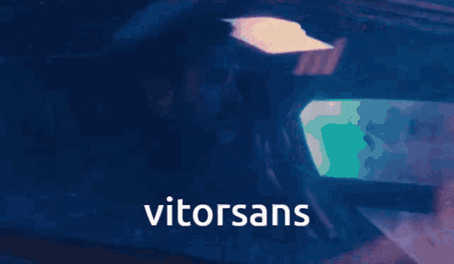 a man and a woman are sitting in a car and the word vitorsans is on the bottom