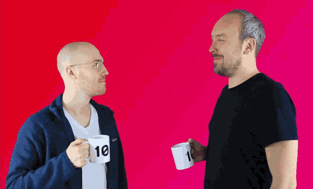 two men are toasting with cups that have the numbers 10 and 12 on them