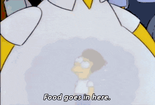 homer simpson says " food goes in here " in front of a crowd