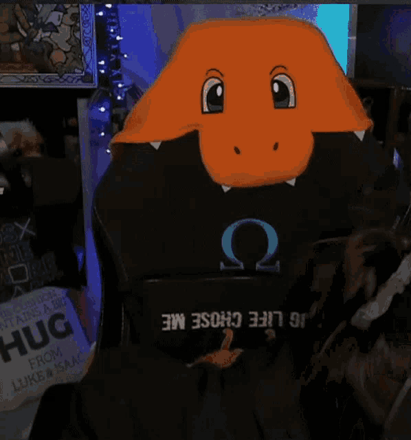 a person is wearing a hat that looks like a dinosaur and has the letter o on it .