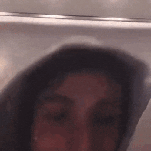 a close up of a person 's face in a hoodie .