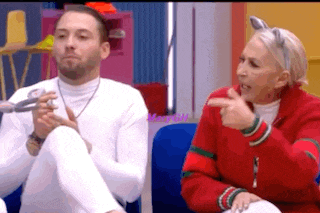 a man and a woman are sitting next to each other on a blue couch .