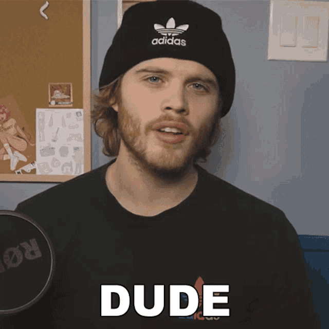 a man wearing a black adidas hat says dude