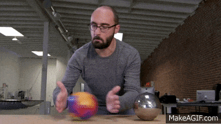 a man playing with a ball on a table with makeagif.com at the bottom of the screen