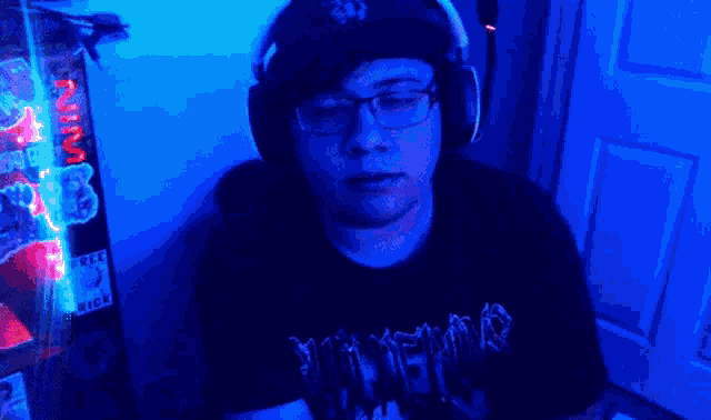 a man wearing headphones and a t-shirt that says slayer