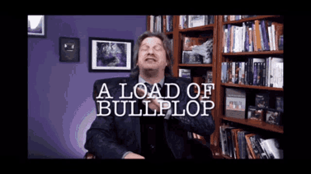 a man in a suit is sitting in front of a bookshelf with the words a load of bullplop above him