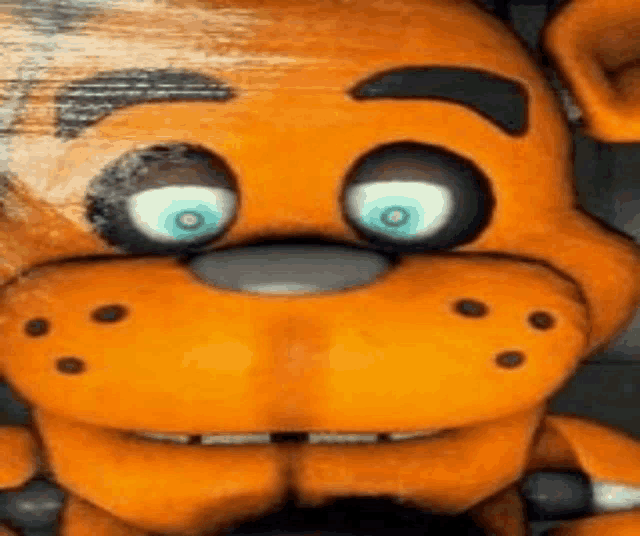 a close up of the face of a five nights at freddy 's teddy bear .