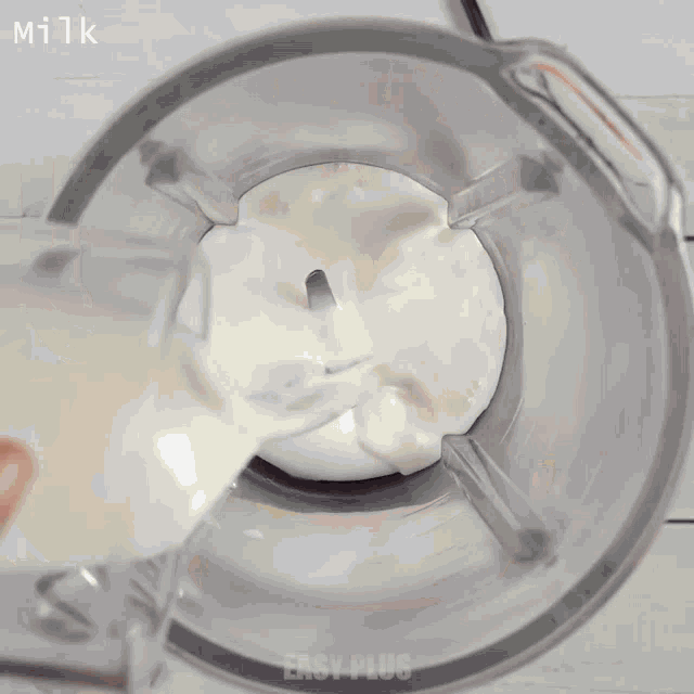 cocoa powder is being poured into a blender