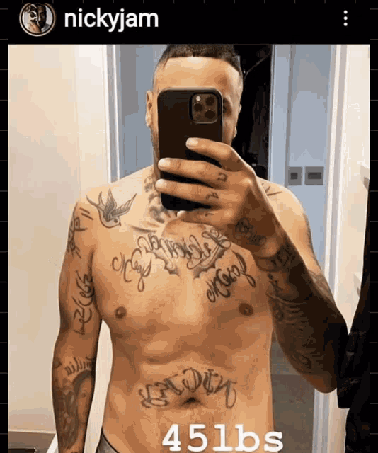 a shirtless man taking a selfie with the name nickyjam on the bottom right