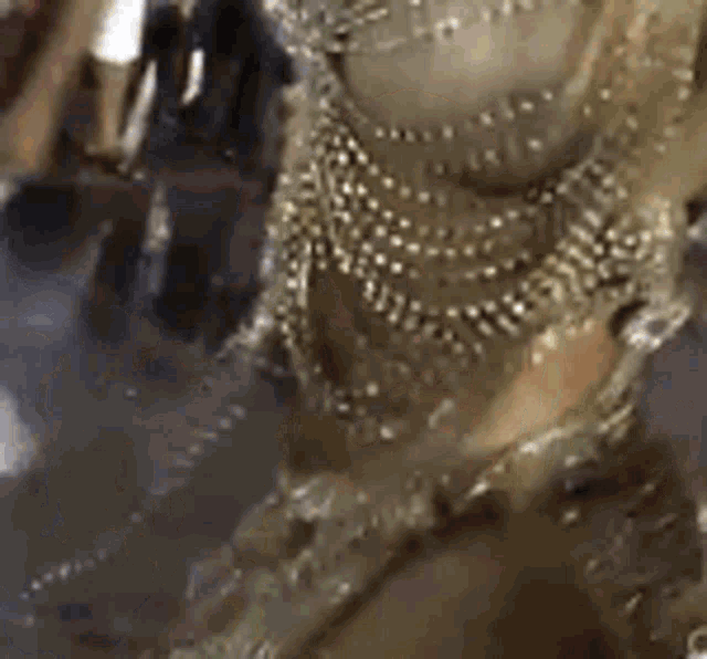 a close up of a person wearing a lot of bracelets and jewelry .