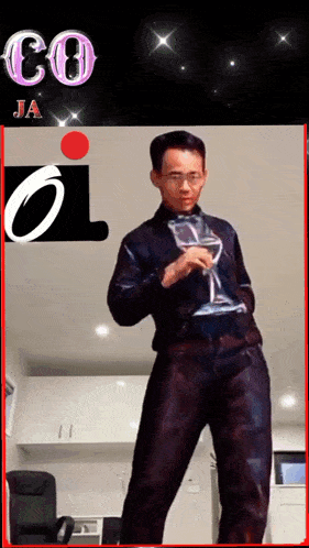 a man is holding a wine glass in front of a sign that says co ja on it