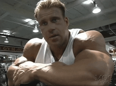 a man in a gym with the word gym on the wall