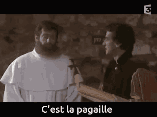 a man with a beard is talking to another man with the words c'est la pagaille written below him