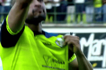 a man is wearing a yellow shirt with the word holma on it