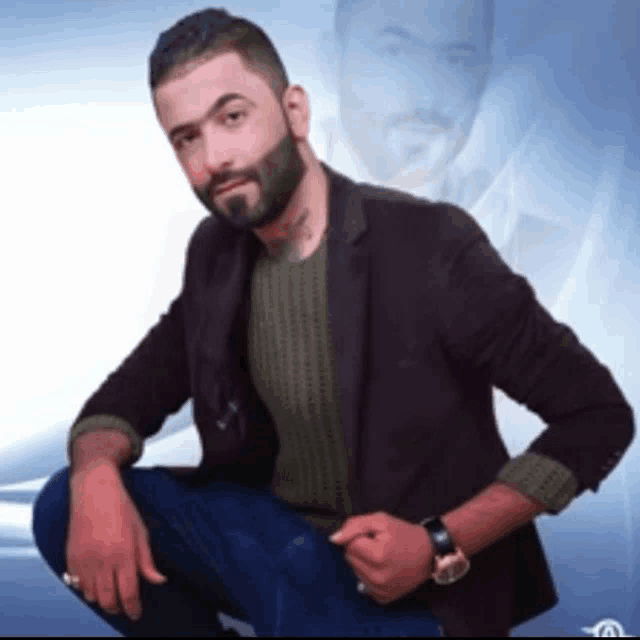 a man with a beard wearing a brown jacket