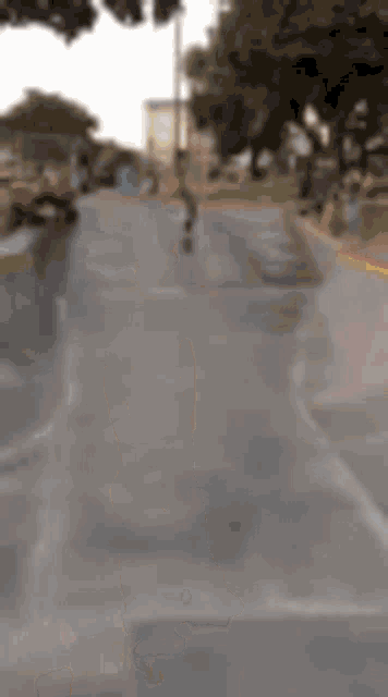 a blurry picture of a person riding a skateboard down a street
