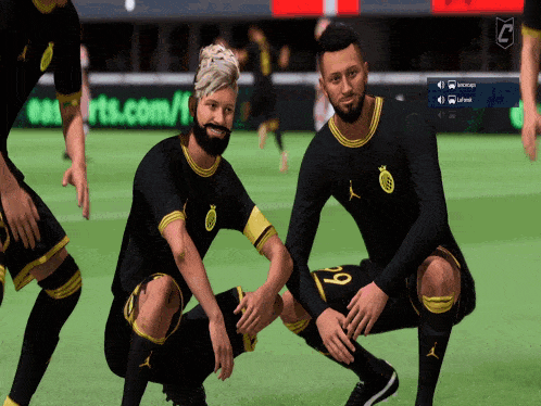 two soccer players wearing black and yellow jerseys with the number 9 on the back