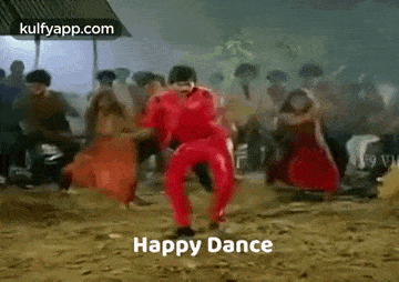 a man in a red outfit is dancing in front of a crowd of people .