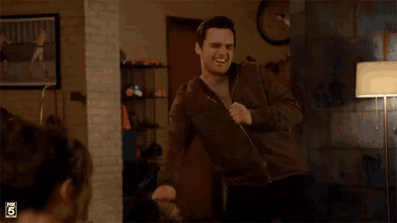 a man in a brown jacket is dancing in a living room with a fox 5 logo in the background