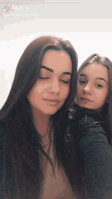 two girls are posing for a picture with their eyes closed and the caption says tiktok
