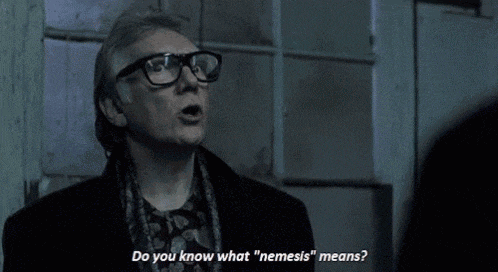 a man wearing glasses says do you know what nemesis " means "