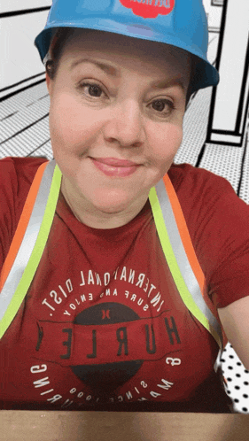 a woman wearing a hard hat and a t-shirt that says " t.310 " on it