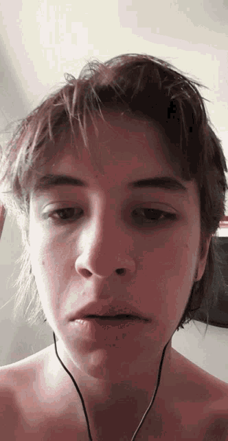 a close up of a person 's face with ear buds on