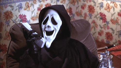 a grim reaper with a mask on talking on a phone