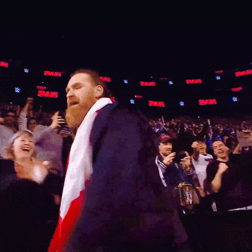 a man with a beard is wearing a red white and blue scarf around his waist