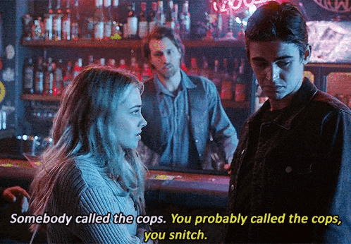 a man and a woman are talking in a bar and the woman says somebody called the cops
