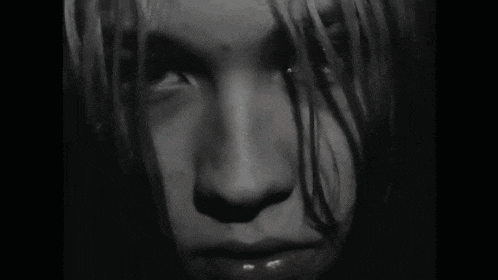 a black and white photo of a person 's face
