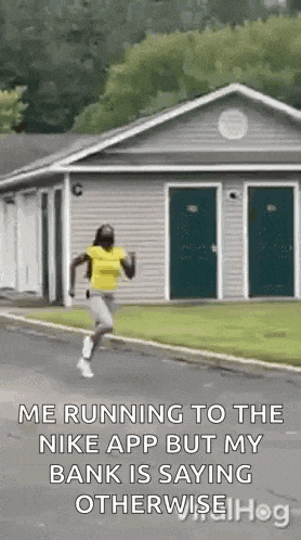 a woman is running down the street in front of a house .
