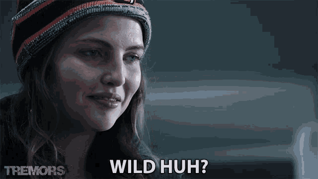 a woman wearing a hat says wild huh while looking down