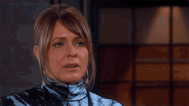 a woman wearing a blue and black tie dye turtleneck sweater