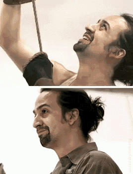 a man with a beard is hanging from a rope and looking up .