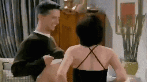 a man and woman are dancing together in a living room .