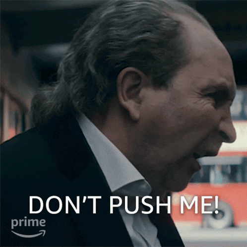 a man in a suit and tie is saying " don 't push me "