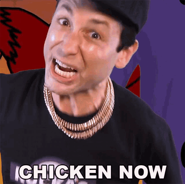 a man wearing a black shirt and a gold chain says chicken now